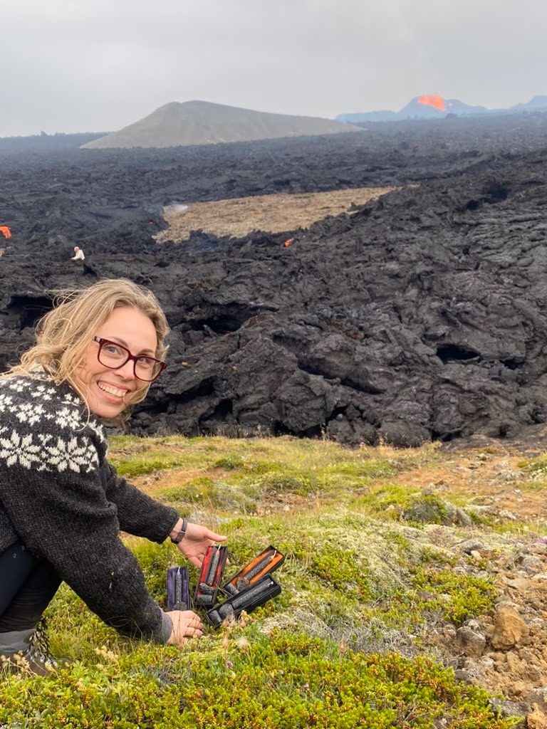 Katrin Huld sitting in front of fresh lava showcasing the lava ritual kits.